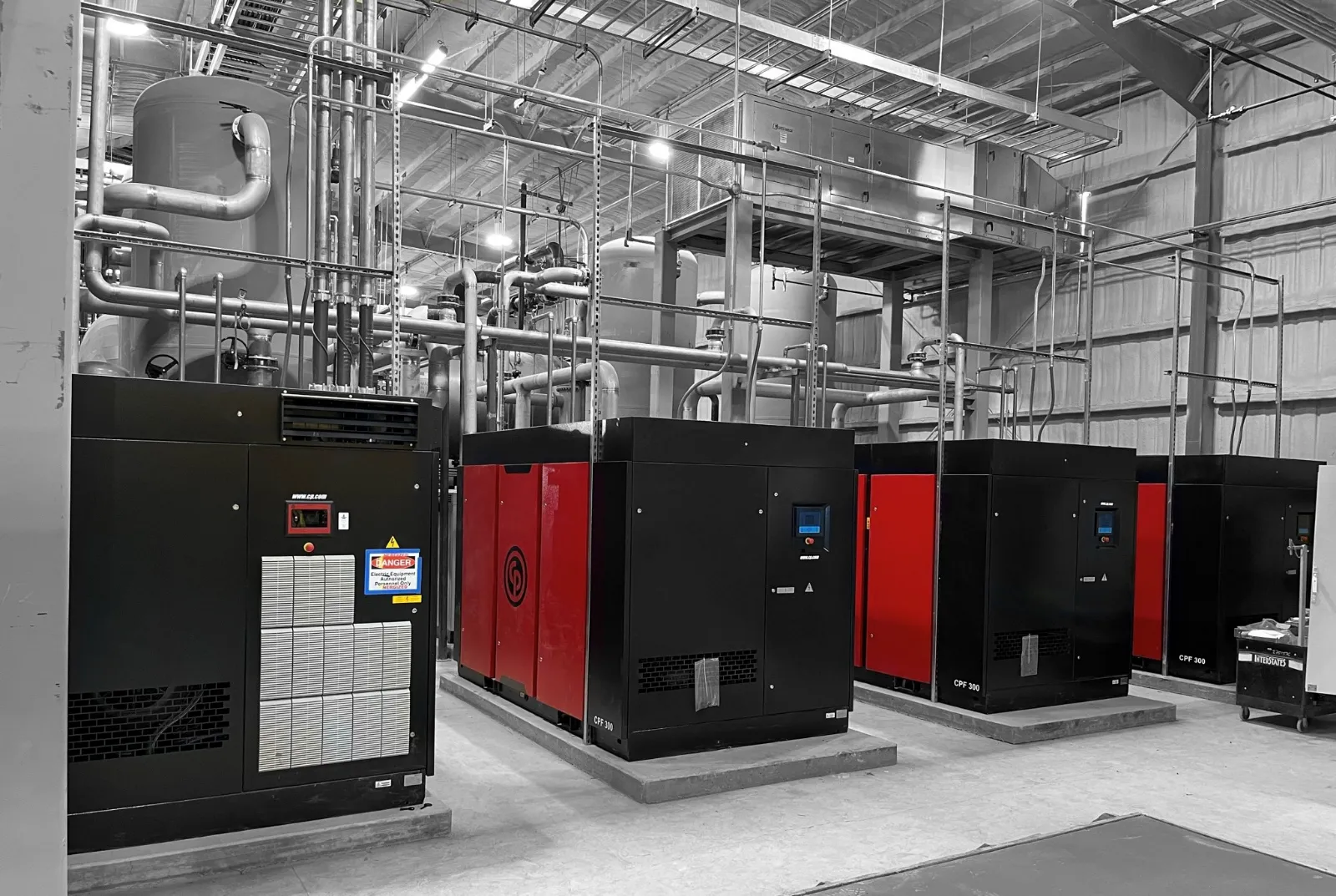 Chicago Pneumatic CPF 300 and CPVS 400 rotary screw compressors with overhead header piping and receiver tanks